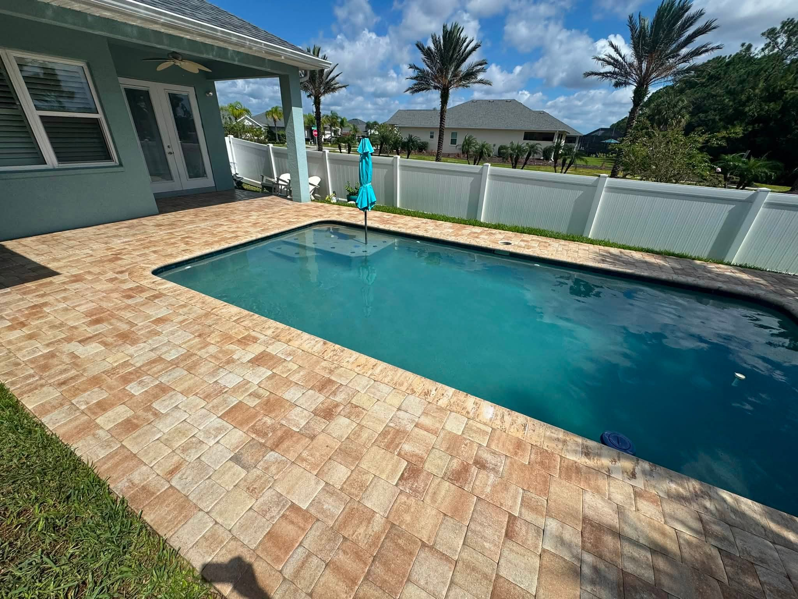 Pool deck pavers after paver sealing by Sunshine Pressure Washing