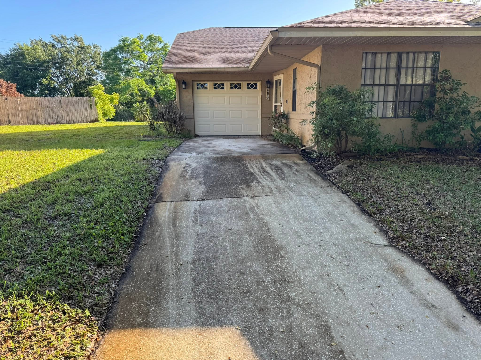 Driveway before pressure washing by Sunshine Pressure Washing